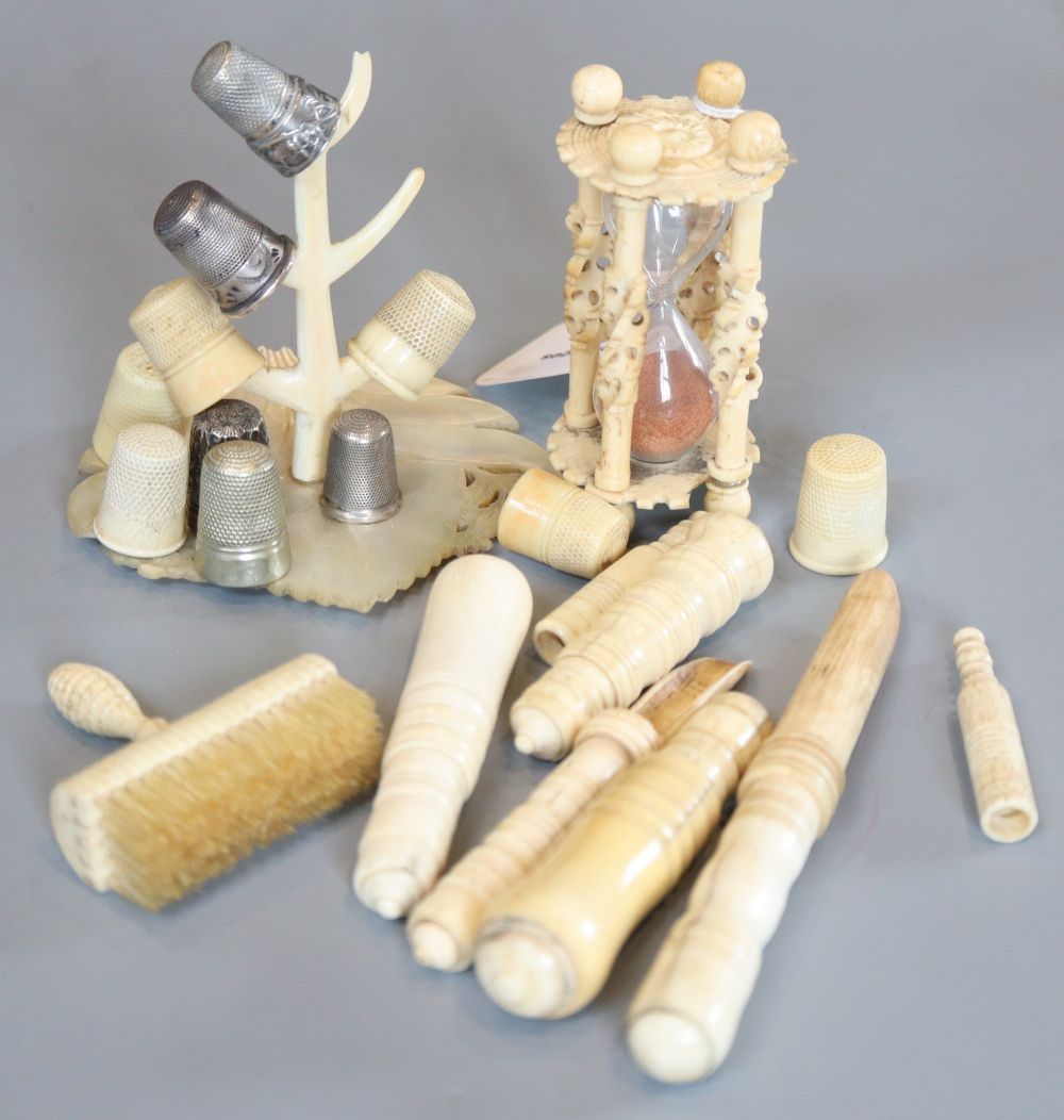 A group of 19th century bone items to include five stilton scoops, an hour glass, a brush, thimbles etc.